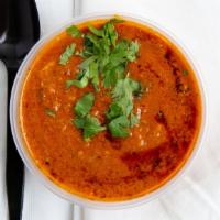 Chicken Curry · Tender chicken in a mild sauce. includes rice naan and daal.