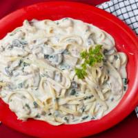 Fettuccine Tetrazzini · Flat noodles prepared in a creamy sauce with pieces of chicken breast, mushrooms, and spinach.