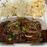 Kalbi Short Ribs · 3 pieces of short rib with sesame seeds and green onions over furikake seasoned rice and mac...