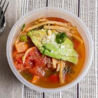 Tortilla Soup · Marinated chicken, fresh vegetables, tortilla strips, queso fresco, avocado, onion.