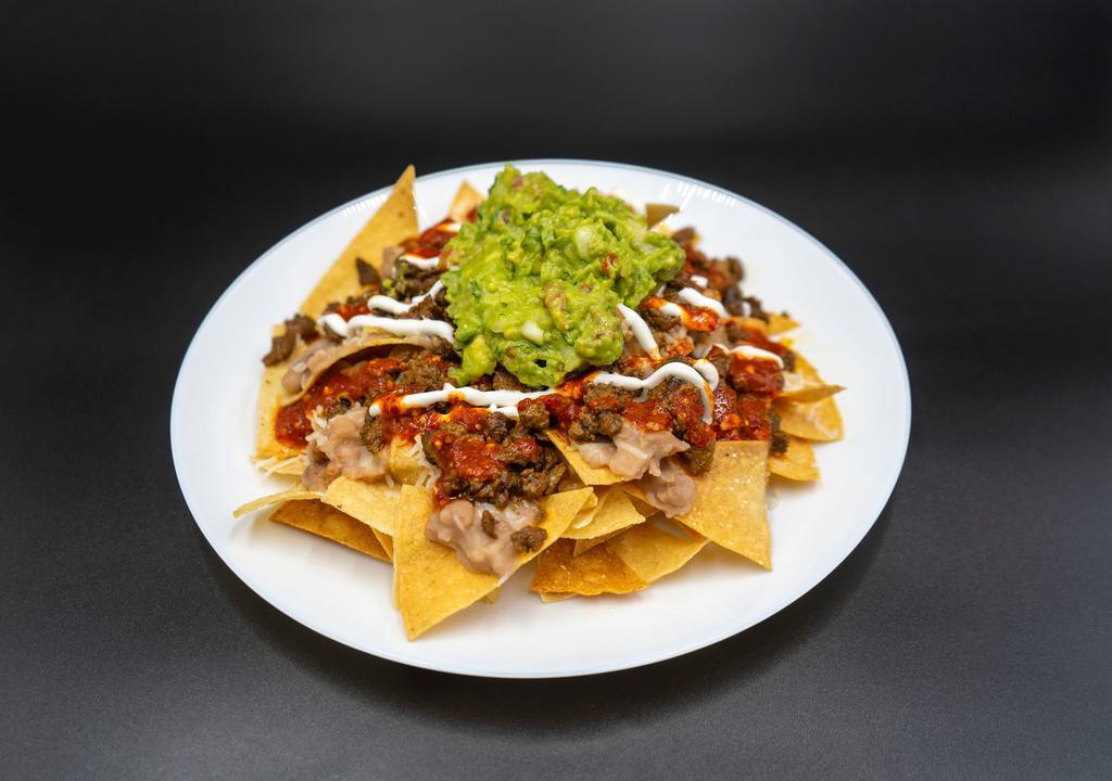 Los Nachos · Chips, Beans, Meat, cheese, Sour cream, Guacamole and Salsa