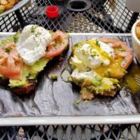 Avocado Toast · Served with two poached eggs, tomatoes, onions, and baby mixed greens.