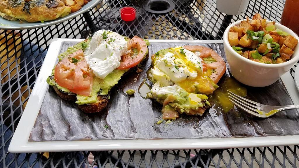 Avocado Toast · Served with two poached eggs, tomatoes, onions, and baby mixed greens.