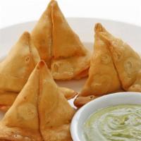 Vegetable Samosa · Two crisp patties stuffed with potatoes & green peas.