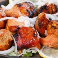 Tandoori Chicken · Half a chicken marinated in yogurt with special herbs & spices.