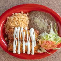 Enchilada Dinner · Two enchiladas with beans, rice and sour cream.
