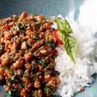 Krapow Chicken Over Rice · Minced chicken stir fried with Thai chilies, garlic, holy basil, and green beans. Served on ...