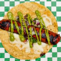 Doggeros Fuego Taco · Corn tortilla, mozzarella cheese, hot link, avocado signature sauce, onion & cilantro.