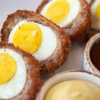 Scotch Egg Bangers · Hard boiled eggs wrapped in Irish sausage, fried and split