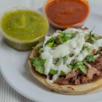 Sopes · Handmade sope, meat of your choice, beans, cilantro, onion, cheese, sour cream.