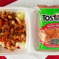 Tostilocos · Bag of tostitos, topped with jicama, cucumber, cueritos (pork skin), peanuts, tamarind candi...