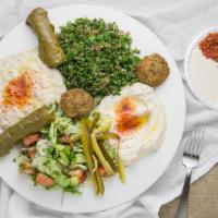 Vegetarian Plate · Hummus, baba ghanouj, salad, falafel, grape leaves, tabbouleh, pickles, and pita bread.