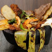 Molcajete · Maria's famous. MARIA’S GRILL FAMOUS MOLCAJETE. Rice and beans & handmade tortillas Includes...