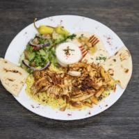 Chicken Shawarma Plate · Served on a bed of yellow rice, side salad, hummus, pita bread, and garlic sauce.