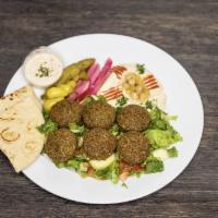 Falafel Plate · 6 pieces, served on a bed of mixed greens, pickled veggies, hummus, pita bread, and tahini s...