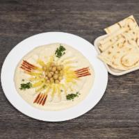 Hummus & Pita Bread · Hummus drizzled with olive oil, paprika, and parsley. Served with warm pita bread.
