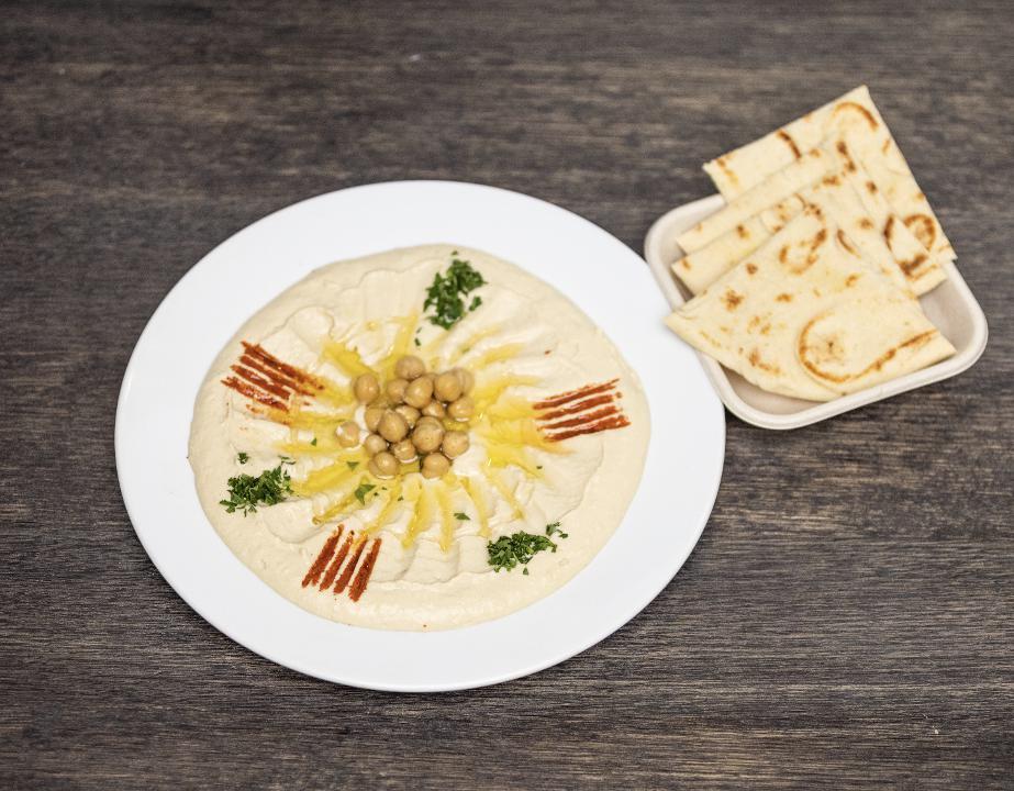 Hummus & Pita Bread · Hummus drizzled with olive oil, paprika, and parsley. Served with warm pita bread.
