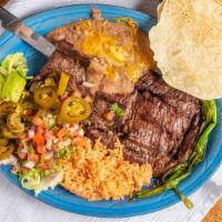 Carne Asada · Tender skirt steak served with rice and beans, guacamole salad, and tortillas.