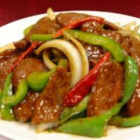 Szechuan Beef · Stir-fried beef with bell peppers and yellow onions in a savory and spicy sauce.
