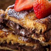 Xtra Stuffed Nutella French Toast · Nutella Stuffed French Toast Topped with Freshly Sliced Bananas, Walnuts and Served Alongsid...