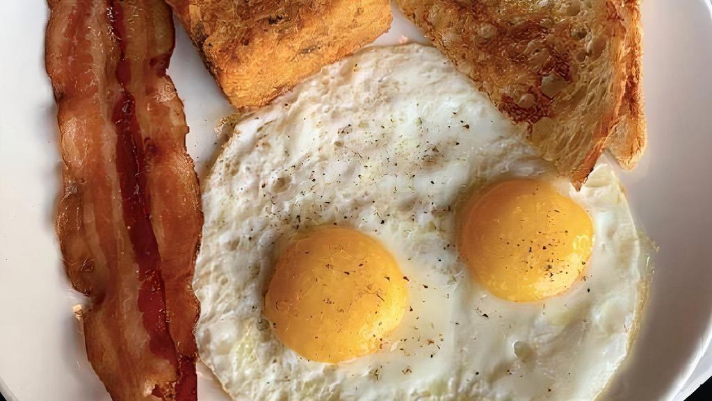 Two Egg Bacon + Sausage Plate · 2 Eggs Any Style, Tater Tots, Applewood Bacon + Home-Made Sausage, and Your Choice of Any Toast - Delicious Classic Breakfast. Add Turkey Bacon or Chicken Sausage for an additional charge.
