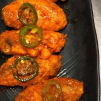Killer Wings · Lightly deep fried chicken wings with a mix of spicy and sweet flavor.