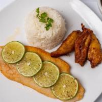 Filete De Pescado Caribeño · Caribbean fish fillet with mojo sauce, white rice, plantains and beans.