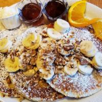 Banana Nut Pancakes · Ripe bananas and walnuts baked in our pancake batter then garnished with pecans and whipped ...