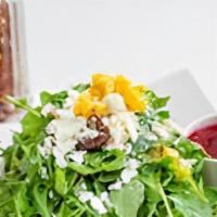 Arugula Salad · Feta cheese, dates, cherry tomatoes, and corn with lemon dressing.
