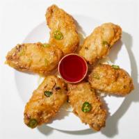 Salt And Pepper Chicken Wings · Chicken wings fried and seasoned with salt and pepper.