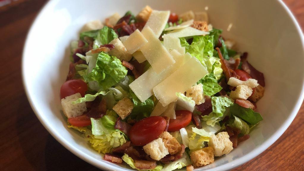 Caesar Salad · Romaine, cherry tomatoes, bacon, garlic parmesan croutons, shaved parmesan, Caesar dressing
