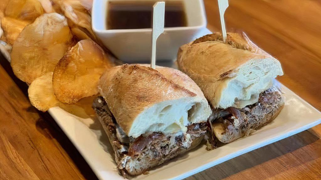 French Dip · Beer Braised Roast Beef, Caramelized onion, Horseradish Cream, Swiss Cheese, House Made Au Jus, Baguette, Fries