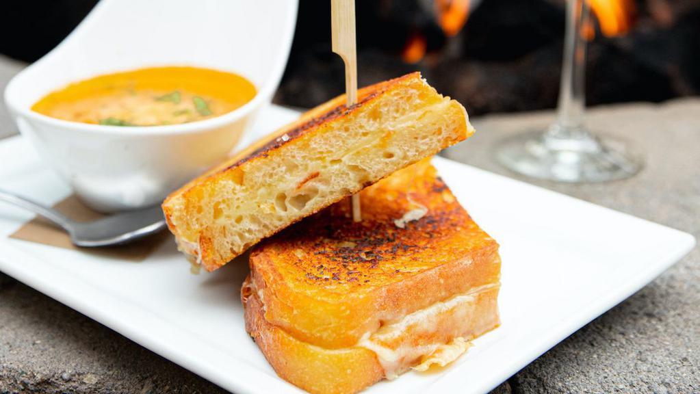 Panini Grilled Cheese · Muenster cheese, English cheddar, gruyere cheese, garlic parmesan sourdough, house- made tomato soup