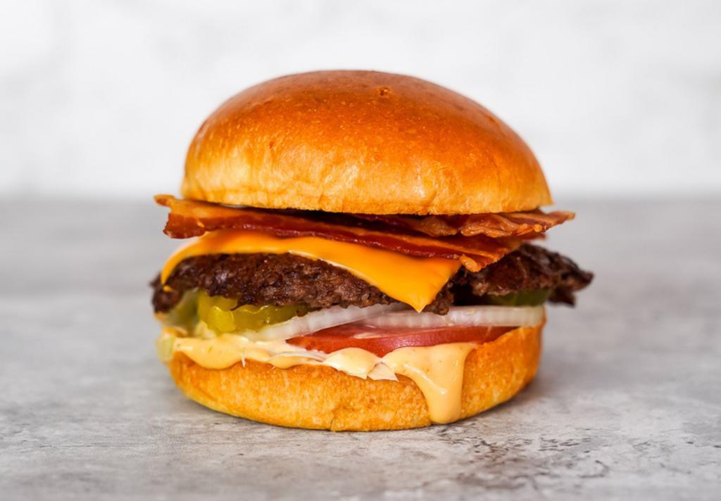 Bacon Smash Cheeseburger  · Juicy, grilled beef burger smashed to perfection with American cheese, turkey bacon, fresh shredded lettuce, sliced tomato, onion, pickles and Smash Sauce on a toasted potato bun