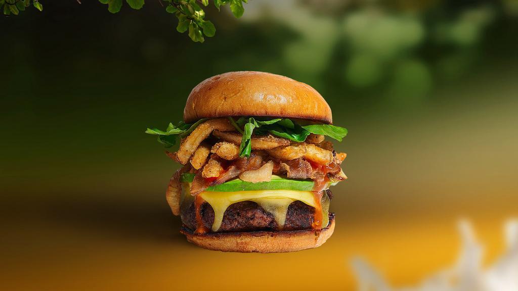 Freedom Fries Burger · Seasoned Beyond meat patty topped with fries, avocado, melted vegan cheese, onion, lettuce, tomato, onion, and pickles. Served on a bun.