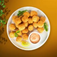 Crispy Tots · Shredded Idaho potatoes formed into tots, battered, and fried until golden brown. Served wit...
