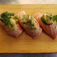 Seared Salmon Sushi  · (3 pieces) Seared Salmon on top of small ball of Sushi Rice. Topped with Cilantro, White Oni...