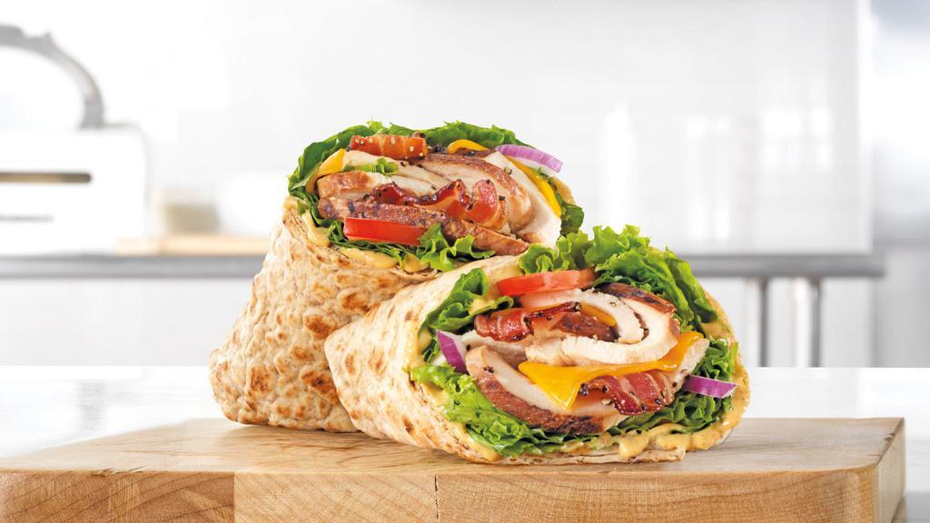Chicken Club Wrap · Slow roasted chicken breast with pepper bacon, cheddar cheese, green leaf lettuce, red onion, honey mustard sauce, and tomato in an artisan wheat wrap. Visit arbys.com for nutritional and allergen information.