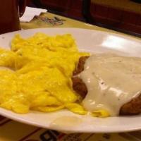 Country Benedict · Biscuits topped with country sausage, two poached/ scrambled eggs and country gravy served w...