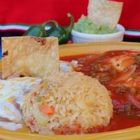 Huevos Rancheros  · Two fried eggs on a corn tortilla covered with our special ranchero sauce, served with rice,...
