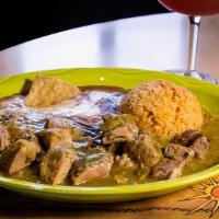Chile Verde · Tender cubed pork covered with our special tomatillo sauce, served with rice, beans and tort...