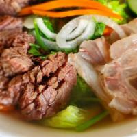 Well-Done Steaks · Premium beef braised with pho broth until tender. Picture is with added tendon and fresh mix...