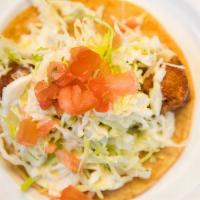 Fish Taco · Deep fried fish battered in our house mix, topped with tomato, cabbage and white sauce.