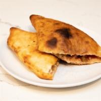 Vegetarian Calzone · Mushrooms, olives, onion, tomatoes, bell peppers, ricotta, and mozzarella cheeses.