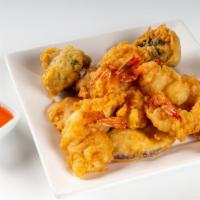 Shrimp Harmony · Large shrimp battered and deep-fried until golden. Served with a deep fried eggplant, brocco...