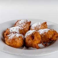Fried Banana · A fresh whole banana is sliced, dipped in a sweet batter then deep-fried golden and dusted w...