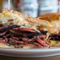 Pastrami Reuben Sandwich · Grilled pastrami, Swiss cheese, sauerkraut and Russian dressing on grilled rye. Served with ...