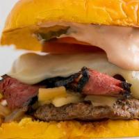 Pastrami Burger · Topped with seasoned grilled pastrami, sauteed onions, tomato, pickle chips, Swiss cheese an...