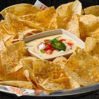 Chips & Queso · It ain't rocket surgery. It's a creamy blend of melted cheeses mixed with roasted red and gr...