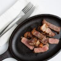 Pan-Seared Steak · New york steak seared with garlic rosemary-infused butter.